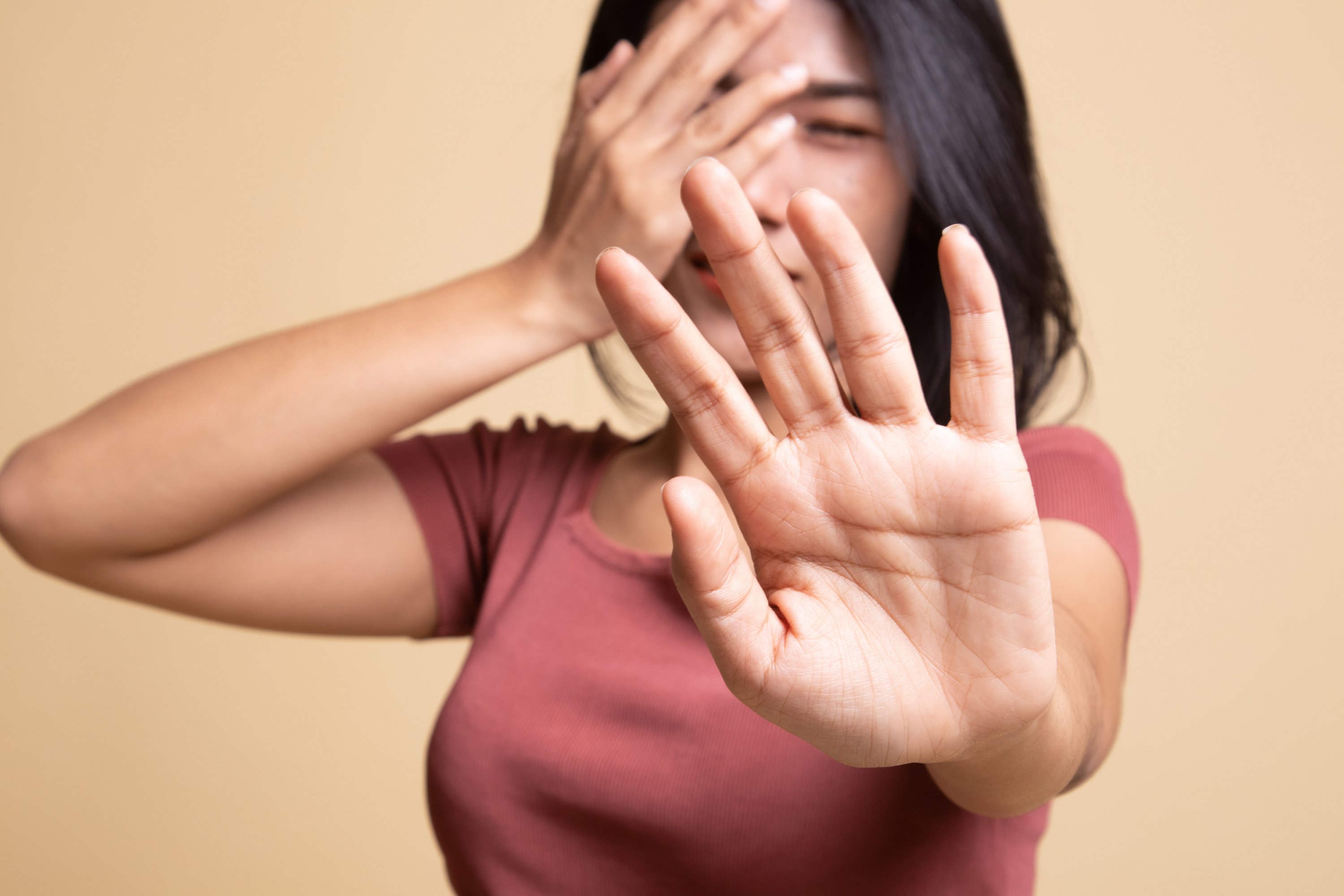 Young Asian woman hide her  face.